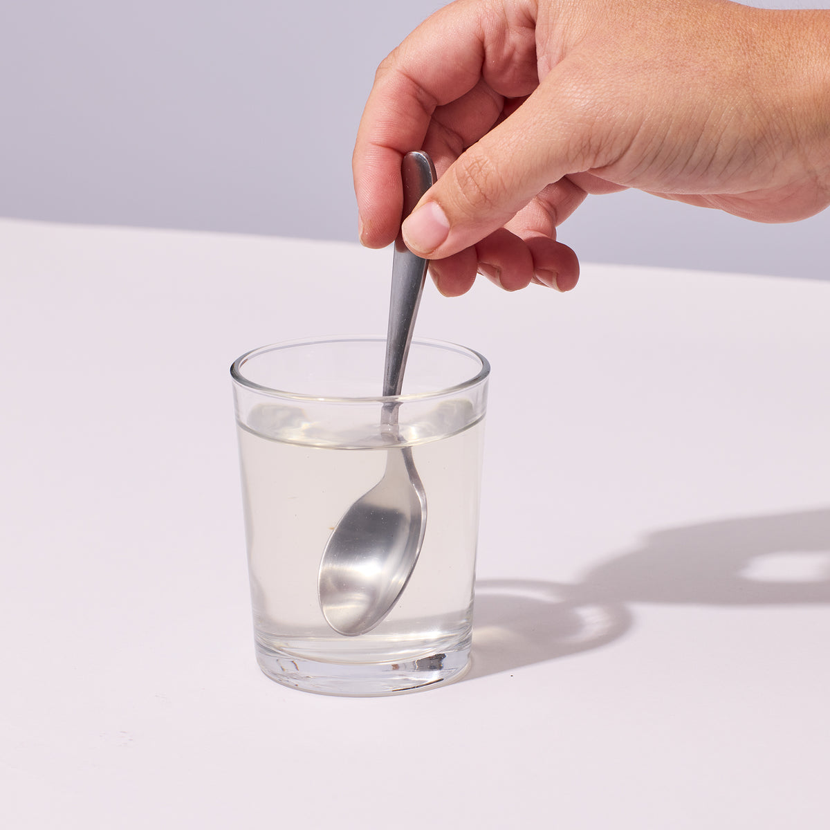 image of person stirring with a spoon