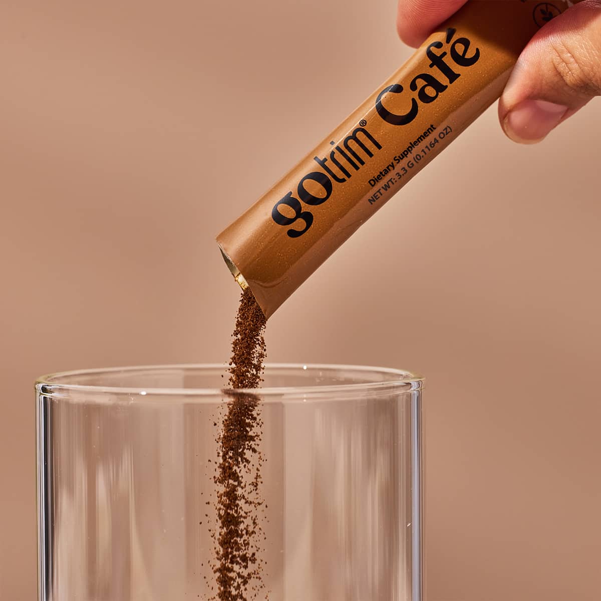 image of someone pouring a stick pack of GoTrim Cafe into a glass