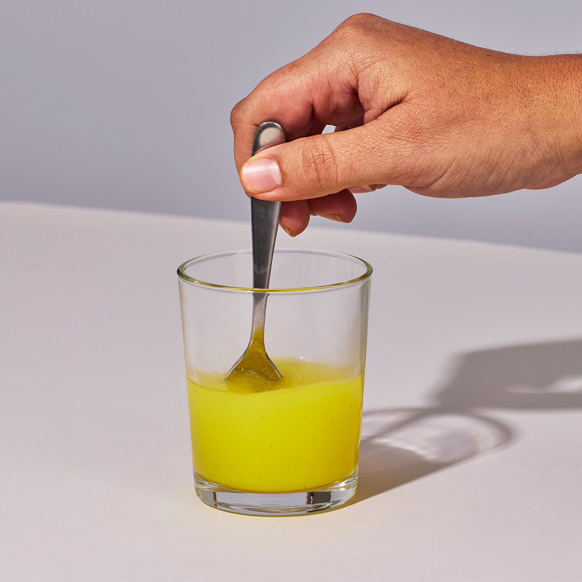 image of person mixing up Isotonix Coenzyme Q10 with water