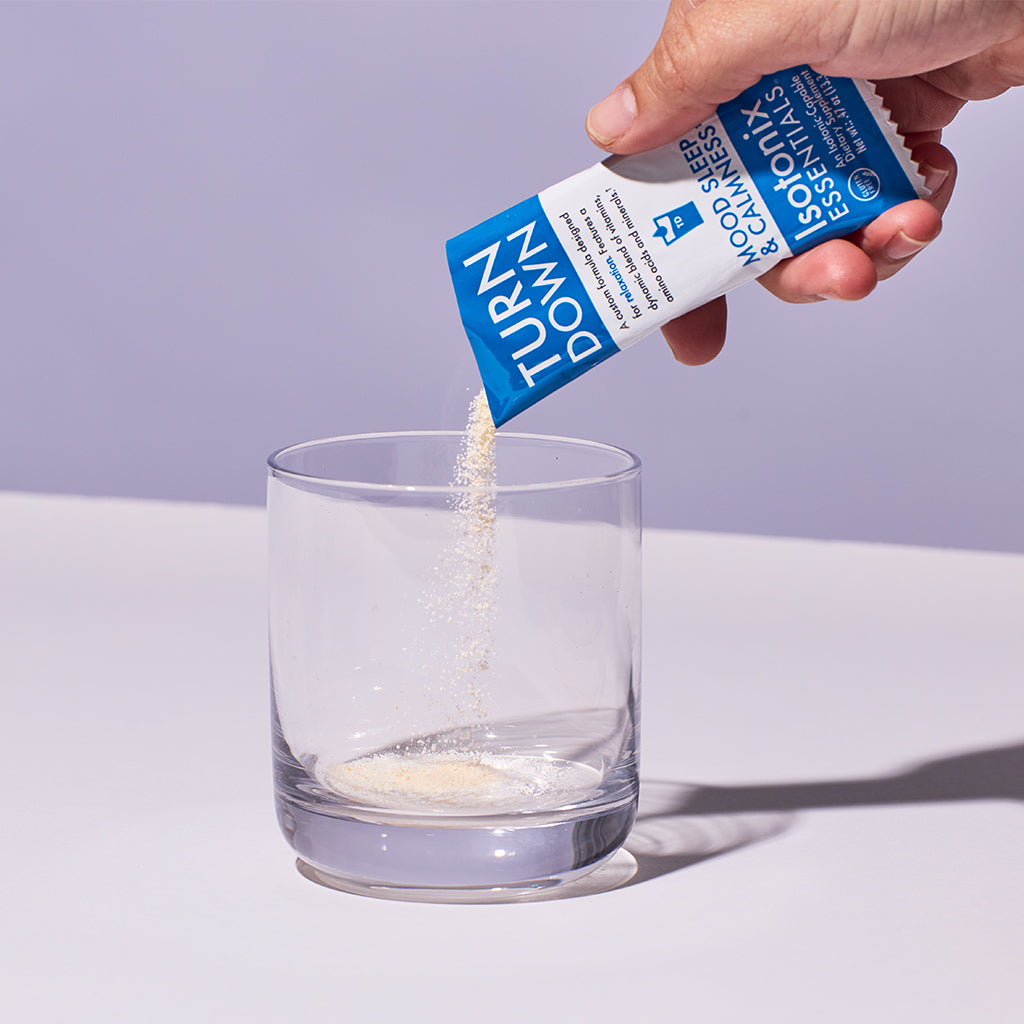 image of someone pouring a packet of Isotonix Turn Down into a glass