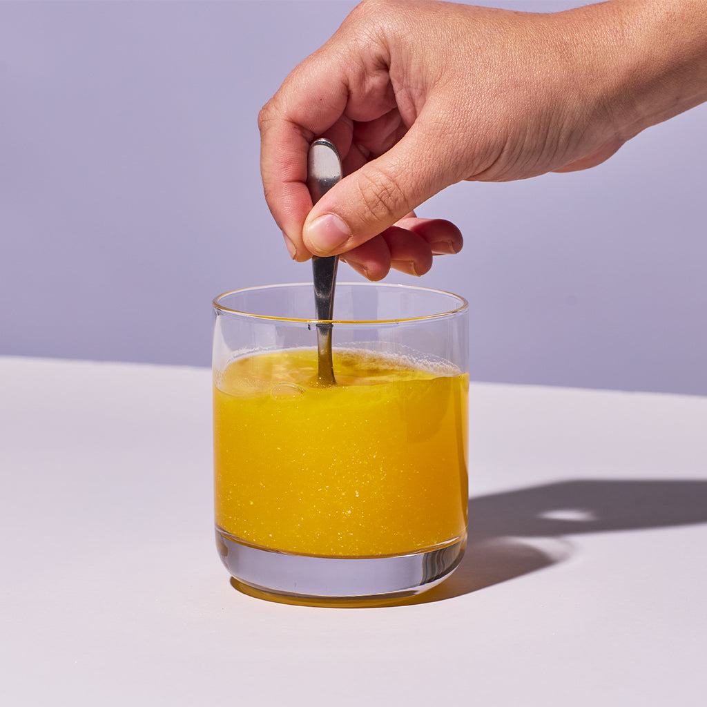 image of someone stiring up Isotonix Turn Down powder with water