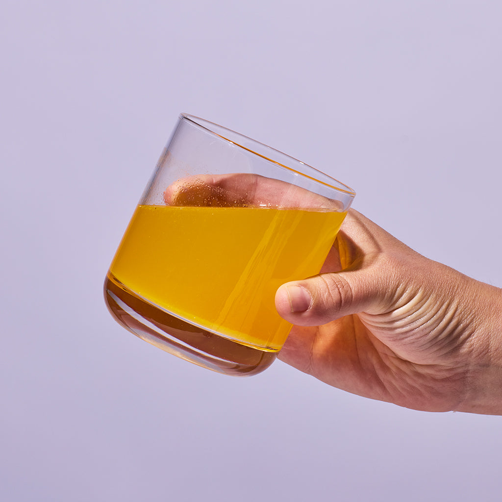 image of someone holding a glass containing one serving of Isotonix Turn Down
