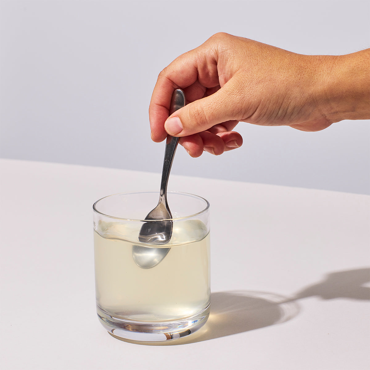 image of person mixing one serving of NutriClean Advanced Fiber Powder with water
