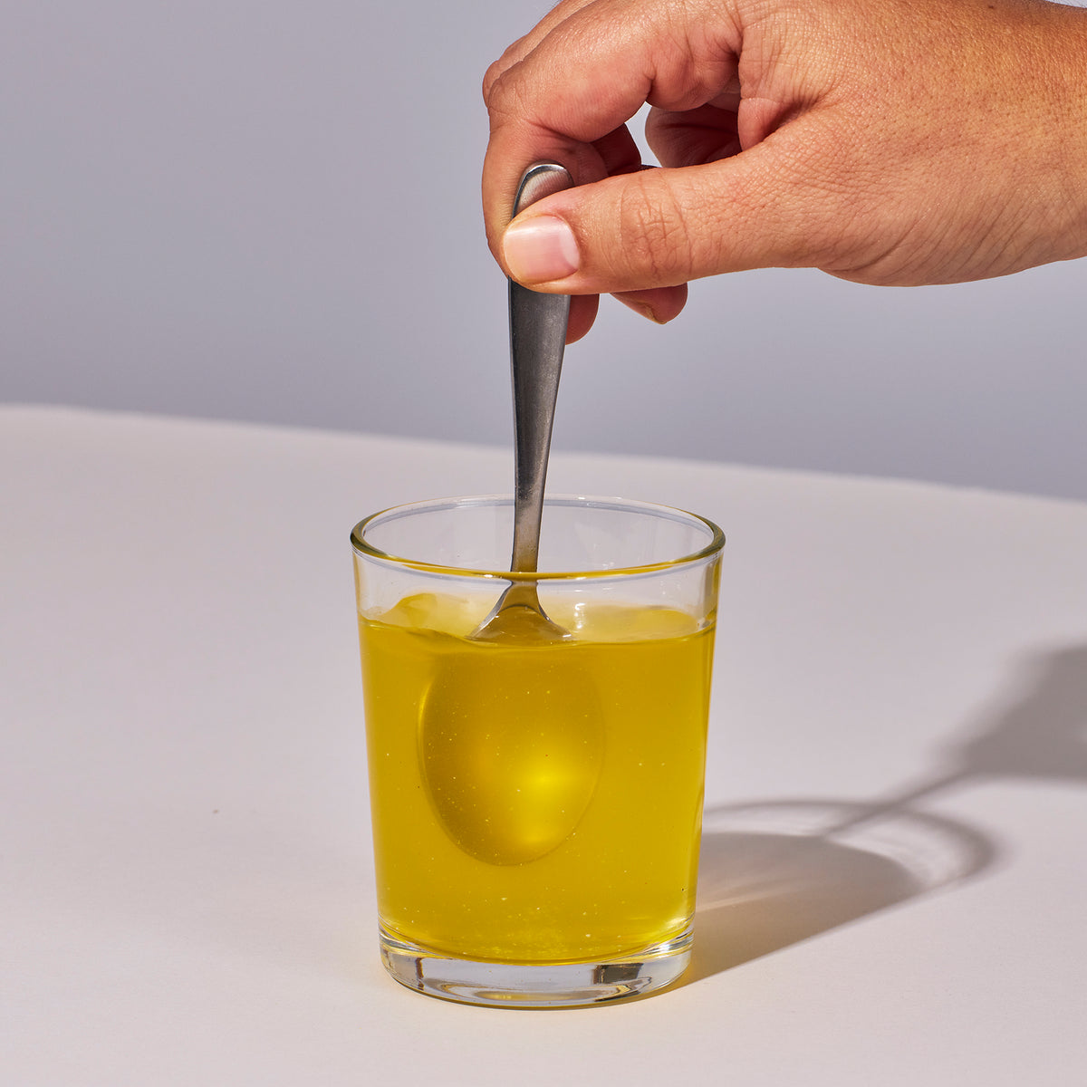 image of a hand mixing up a serving of Isotonix Multimineral with water