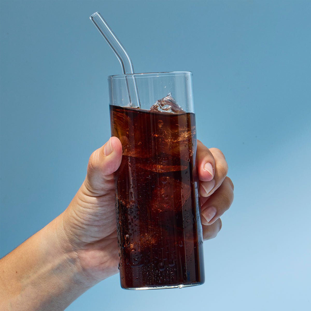 image of someone picking up glass with a serving of GoTrim Tea in it