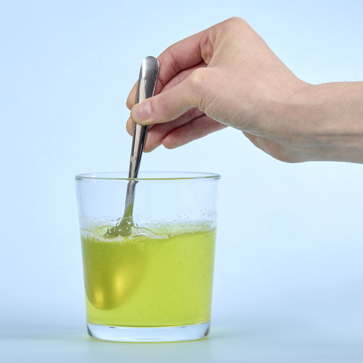 image of person mixing up Isotonix Activated B in a glass