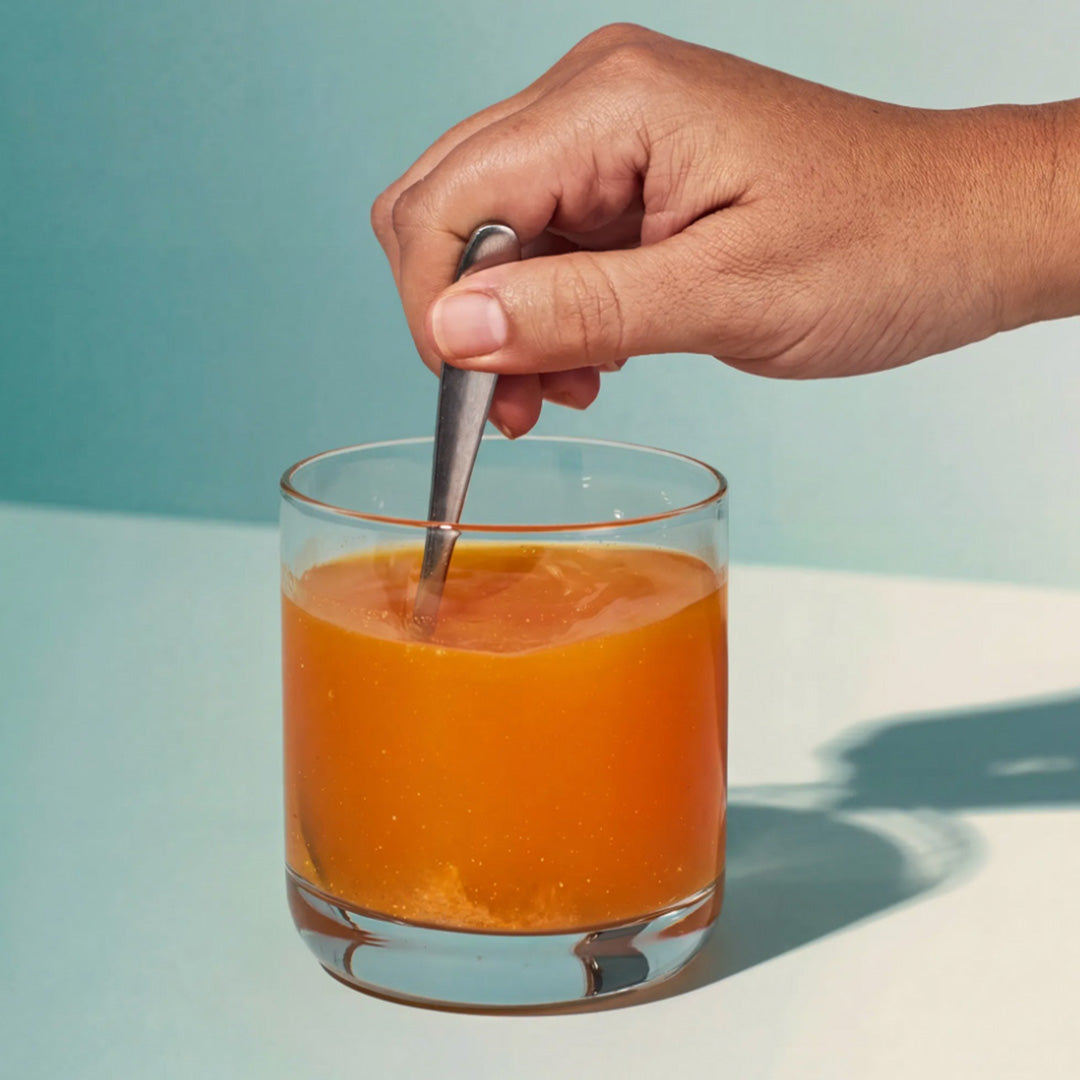 image of person mixing Isotonix Essentials Anti-Aging powder with water