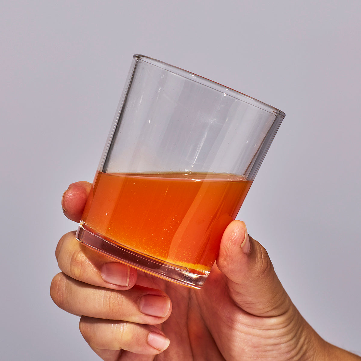 image of person holding a glass containing one serving of Isotonix Vision with Lutien