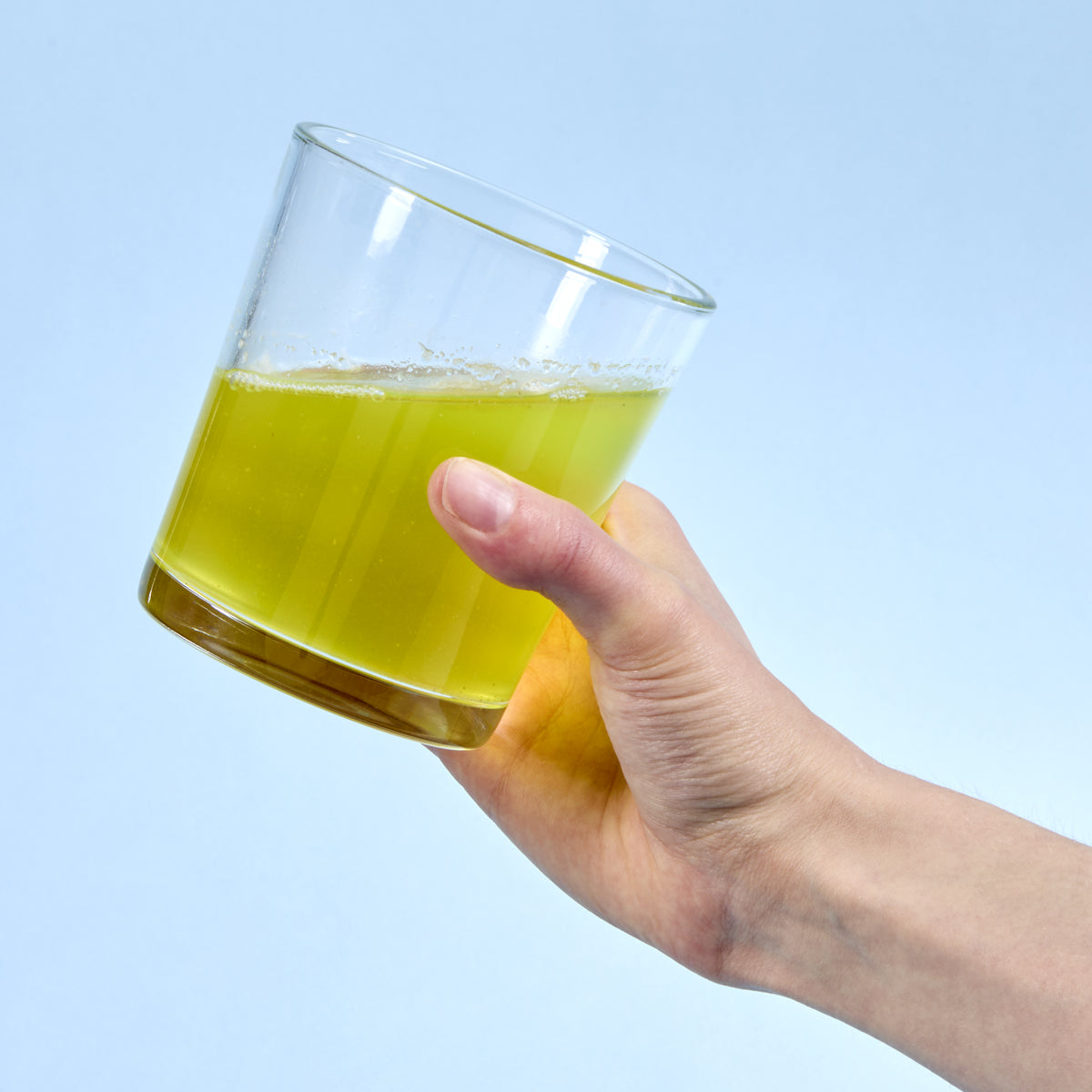 image of person holding a glass of Isotonix Activated B