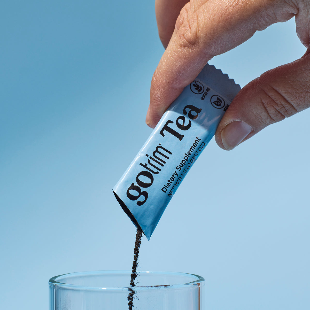 image of someone mixing a packet of GoTrim Tea into a glass