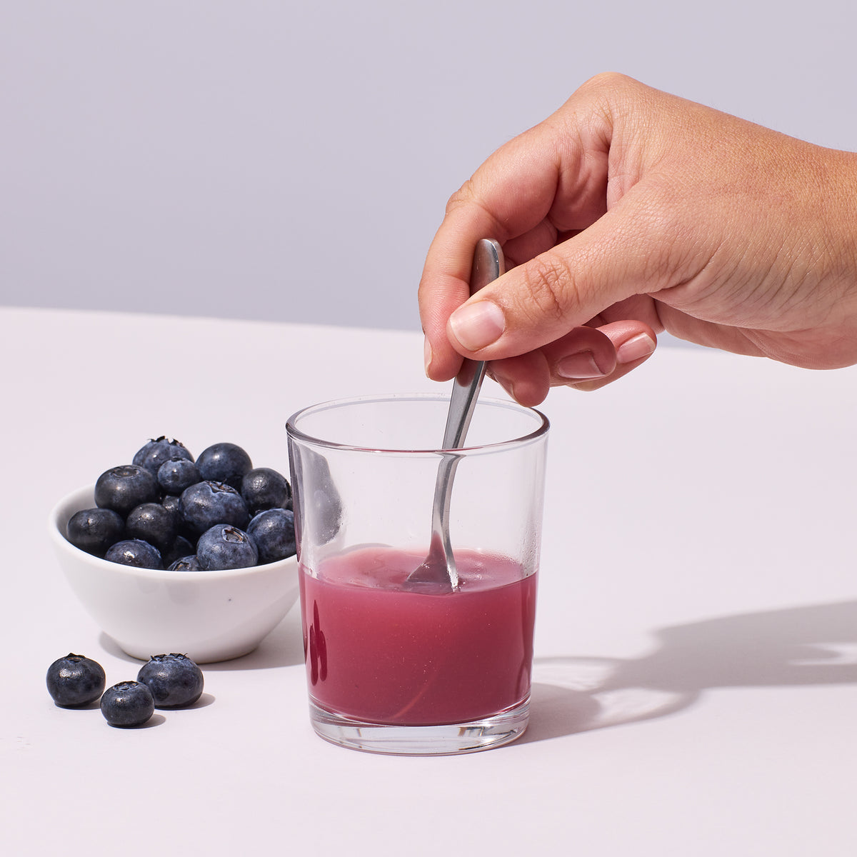 image of person mixing up a serving of Isotonix Maximum ORAC with water