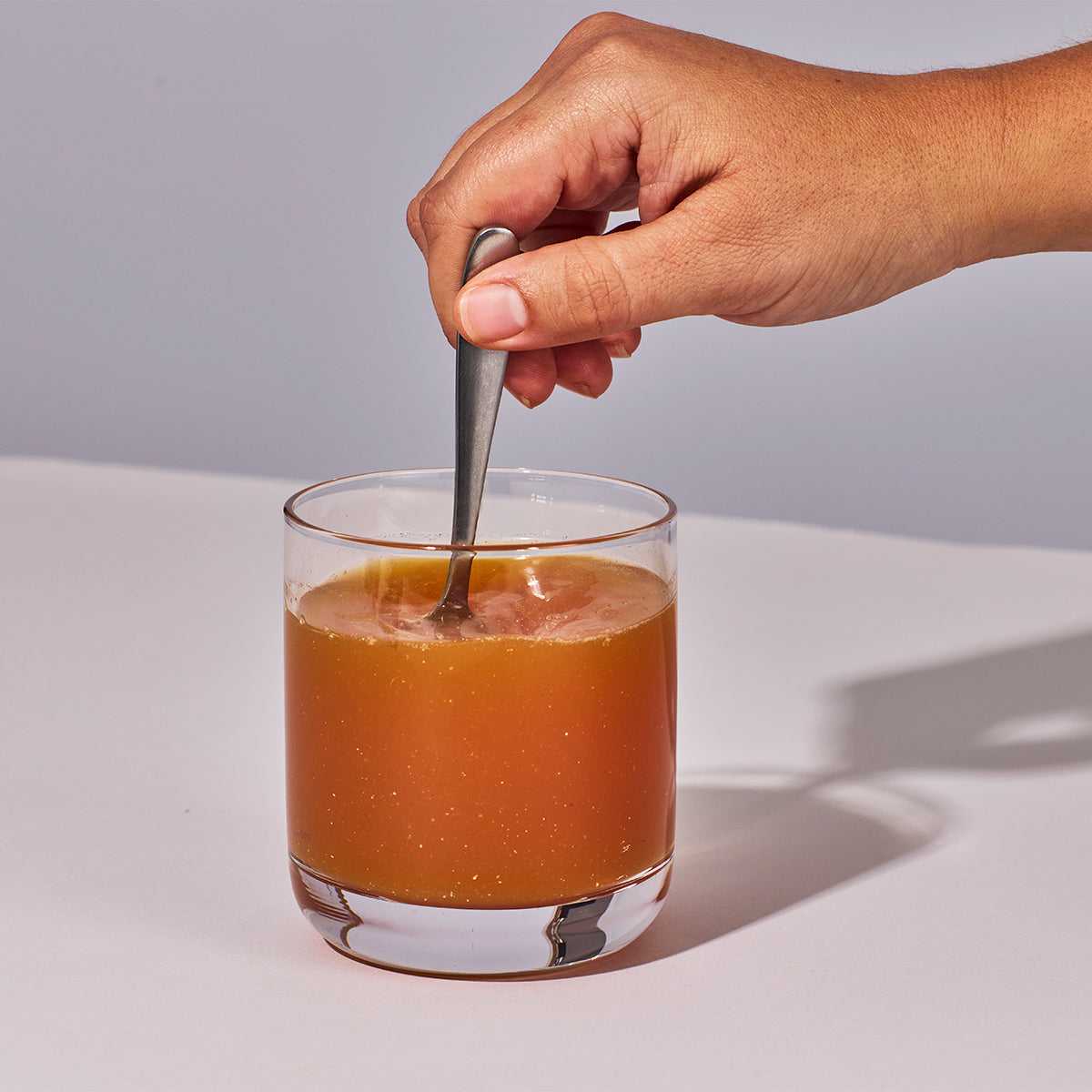 image of person mixing up Isotonix Essentials Women's Health Powder with water